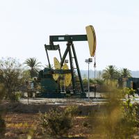 An oil pump jack in the desert.